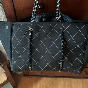 Classic black and white tote with attached zippered compartment!
